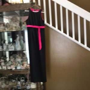 Black gown with hot pink slit on side.